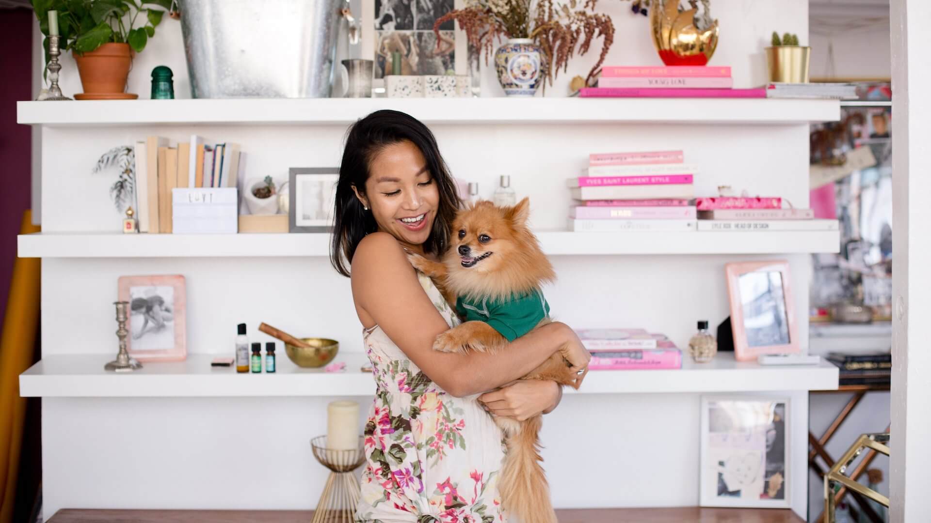 A lady carrying a dog